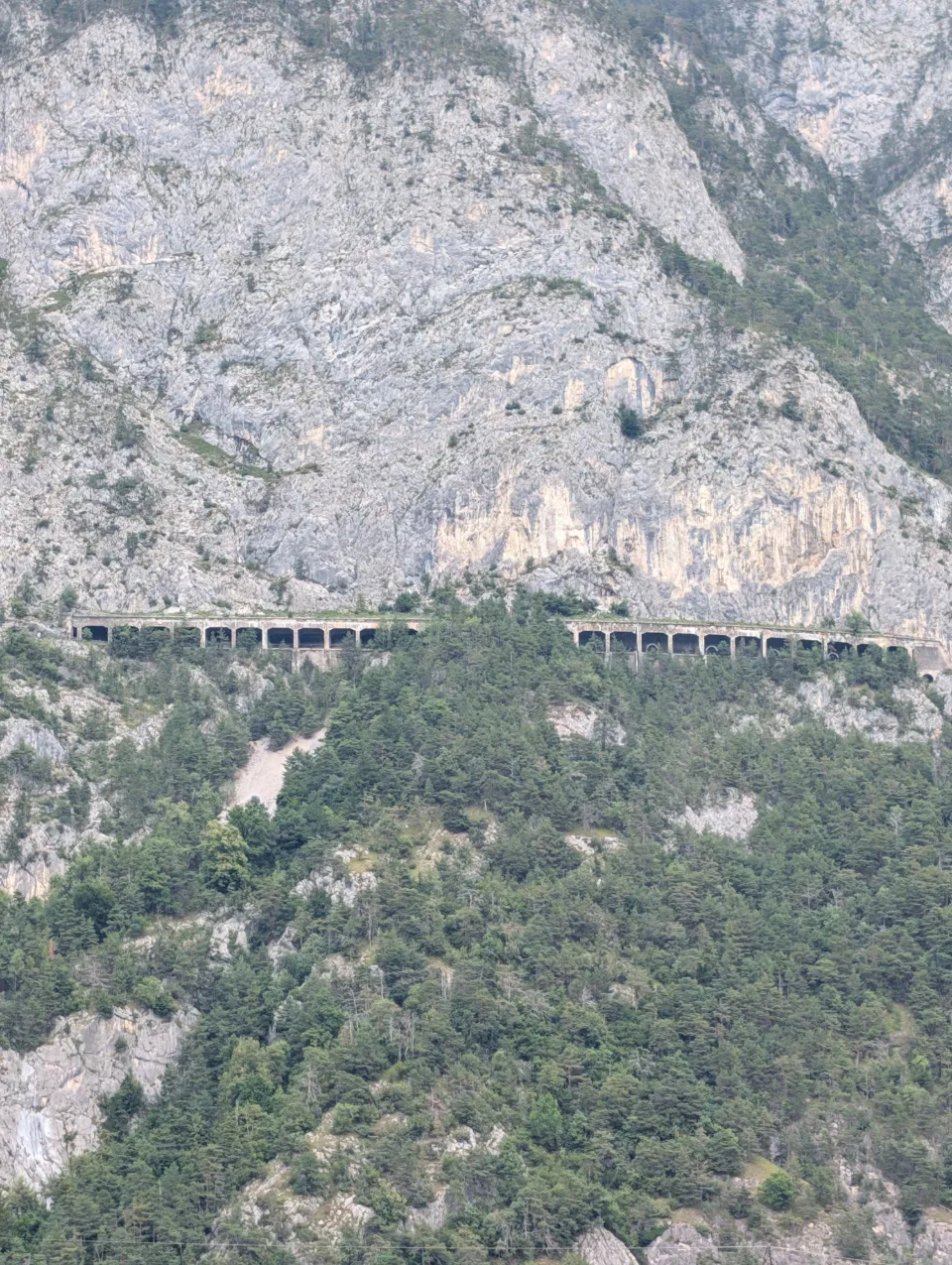 Mountain-road bridge cutting through the rock face