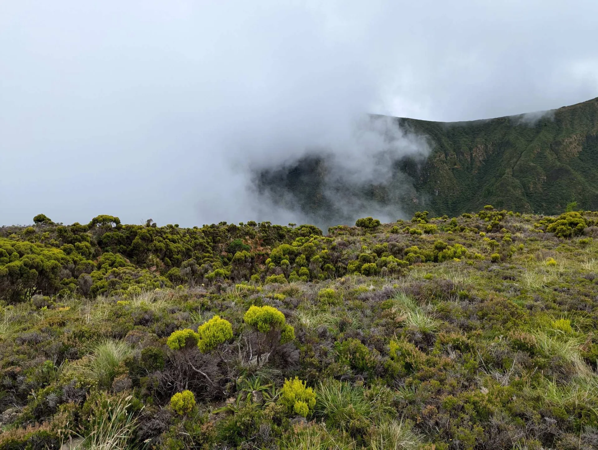 Mist drifts over the crater rim of Lagoa do Fogo