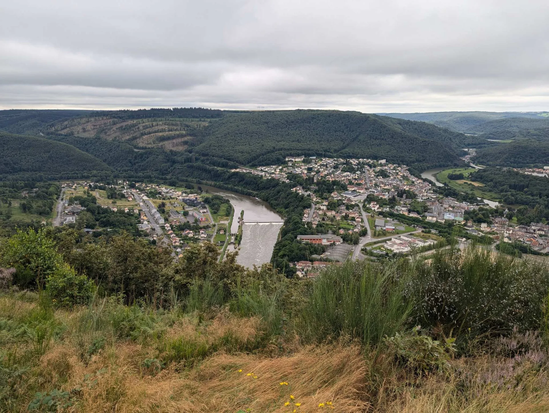 Revin and the weir in the Meuse, seen from the wooded heights.