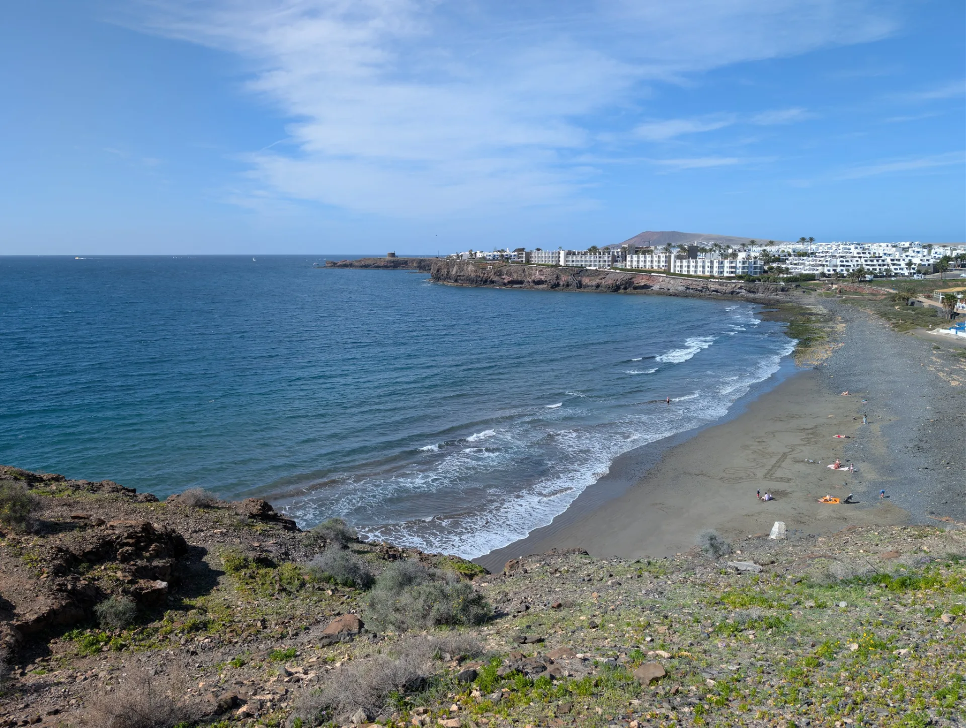 The town of Playa Blanca on its bay, turquoise water in front.