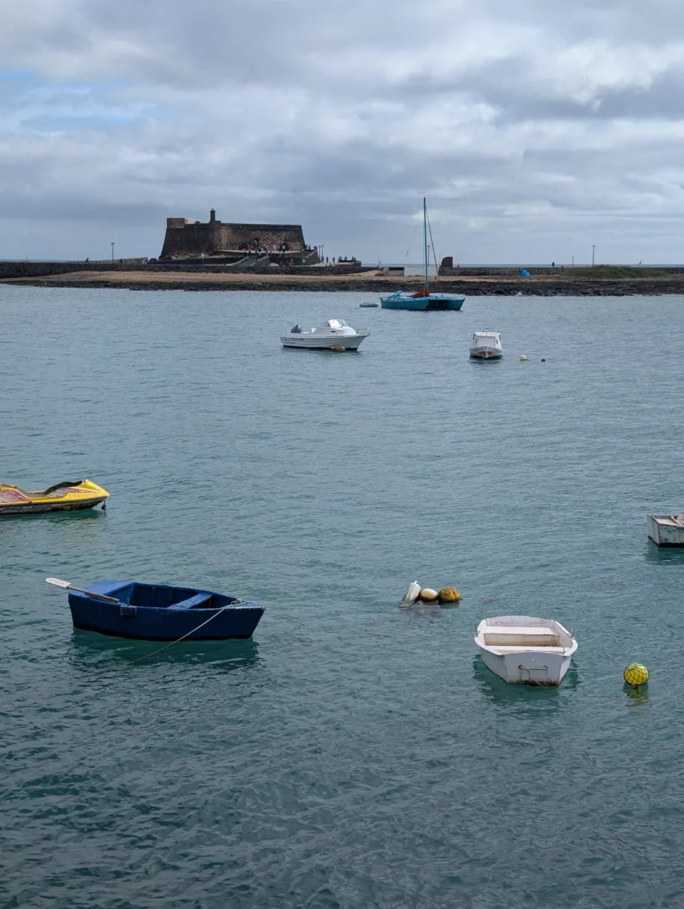 The Castillo de San Gabriel on its islet, fishing boats in front.