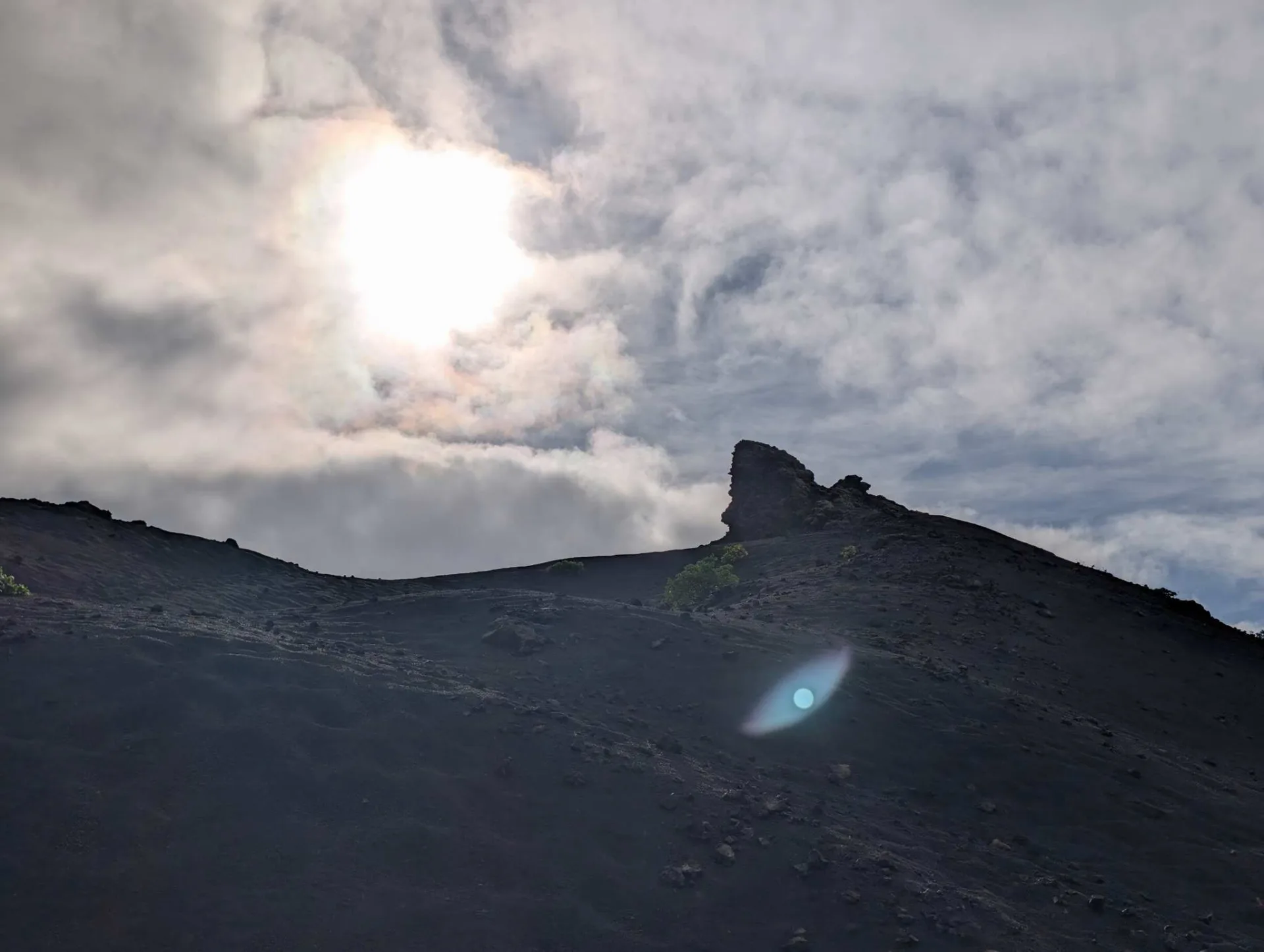 The cone of El Cuervo backlit by the low sun.