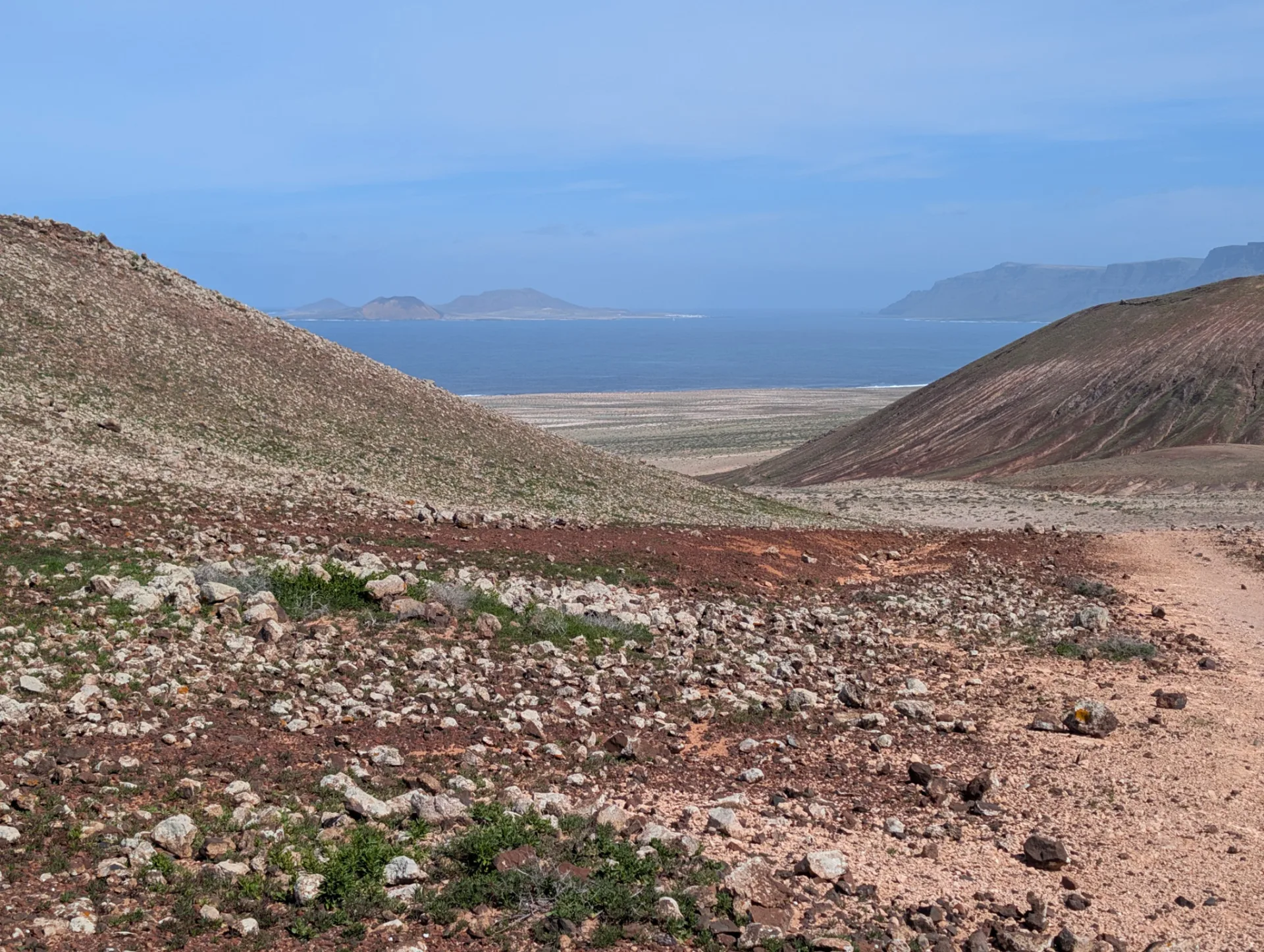 A green valley running down towards Famara beach.