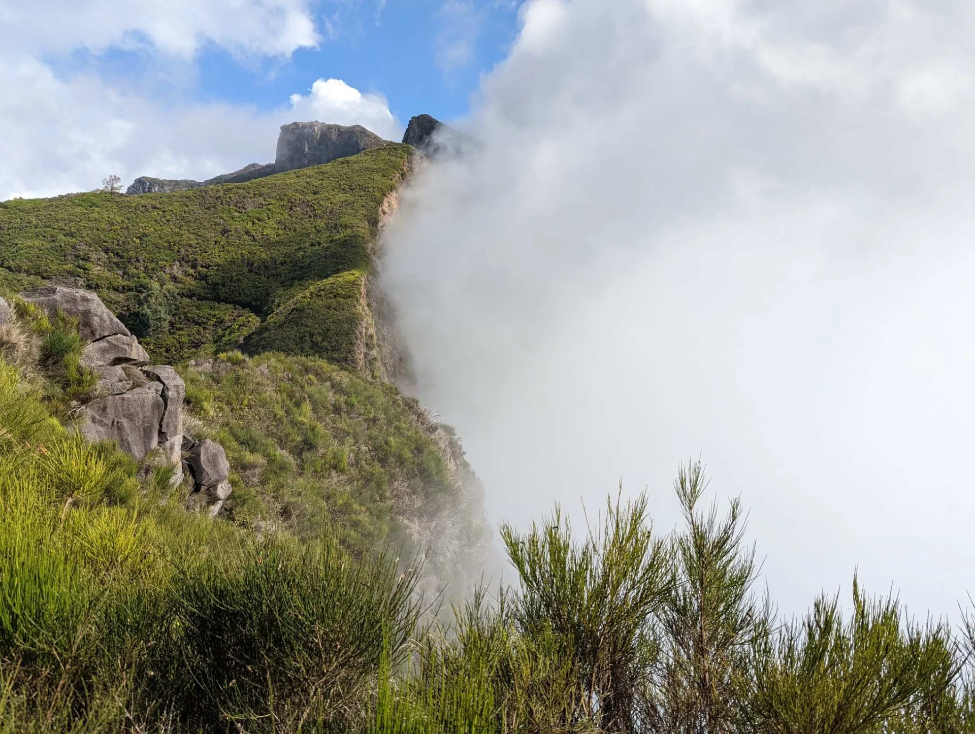 Clouds spilling over the mountain ridge