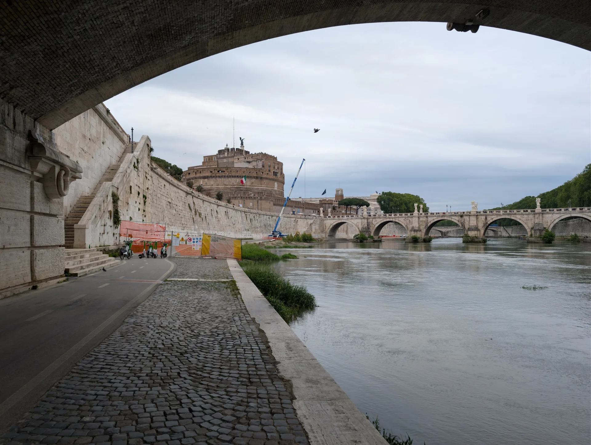 Castel Sant'Angelo framed through a bridge arch