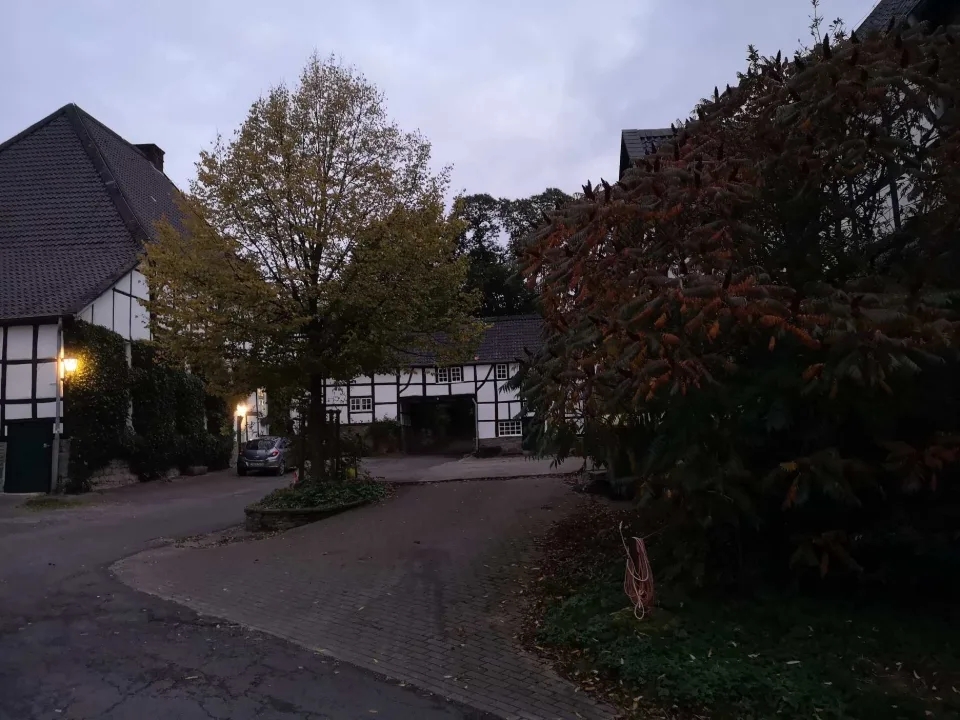 Arriving at dusk: the lit windows of a half-timbered house, the day is done.