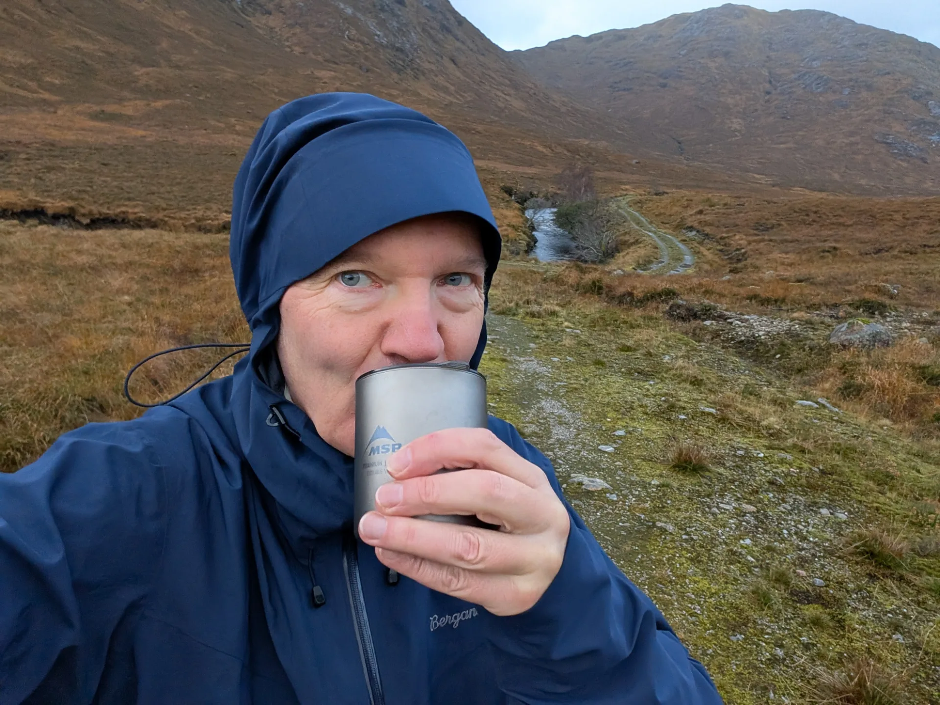 First cup in the rain — the mug steams, the path stretches on